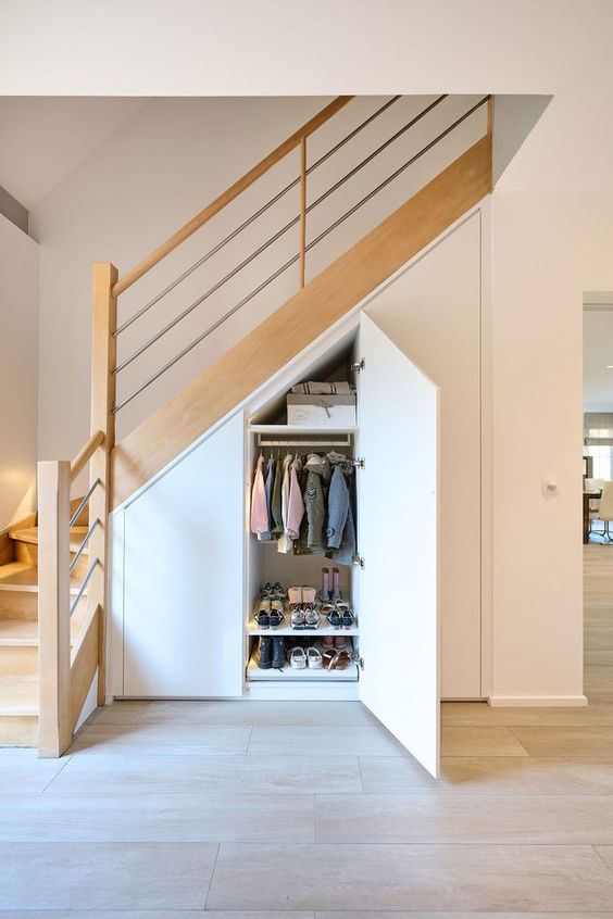 a wardrobe built into the staircase is a cool idea, especially if you don't have space for a mudroom