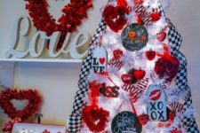 a whimsy tabletop Valentine tree with checked ribbons, lights, red rose wreaths, red heart ornaments and tags
