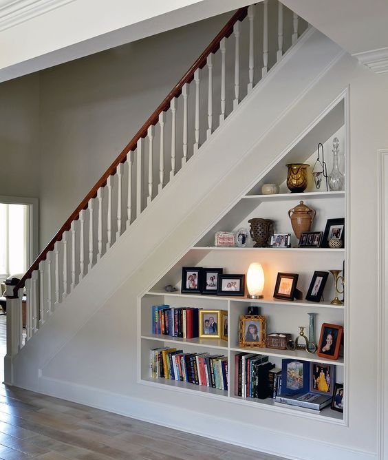 an open storage under built into the staircase is a cool bookcase that doesn't require any floor space