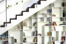 an open storage unit built into the staircase is a cool idea and you may use it as a bookcase if you want