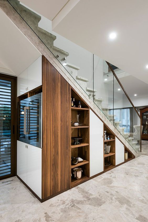 built-in niche shelves, a wine cooler right in the staircase are a cool idea