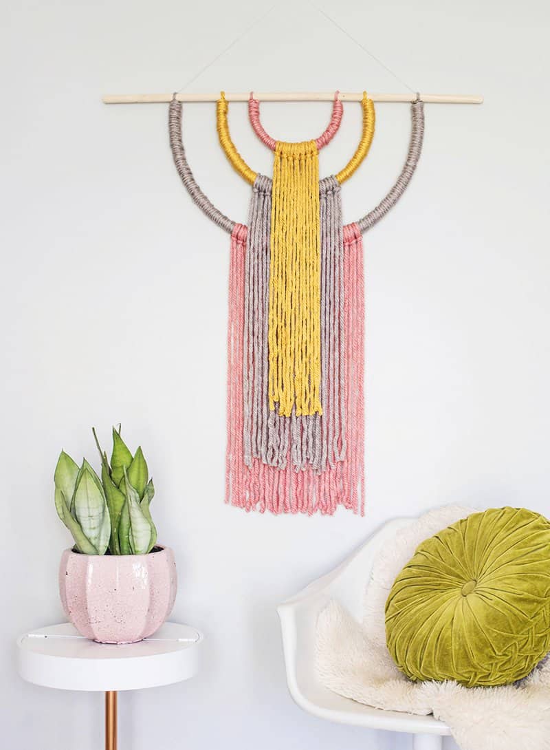 DIY colorful yarn wall hanging with catchy shapes