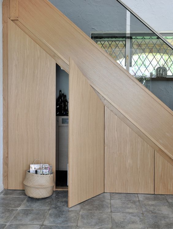 hide some storage compartments under the stairs but add matching doors to make them look sleek