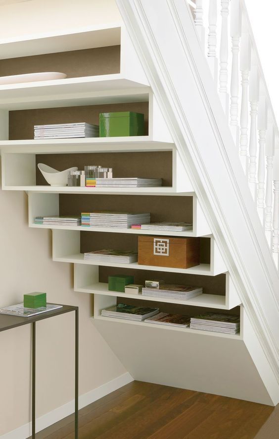 shelves built into the staircase itself and some additional coffee tables are a non-typical solution