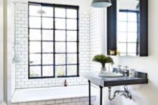 02 an industrial bathroom with white subway tiles, black grout and black accents in the bathroom for some drama