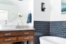 04 navy subway tiles accentuate the bathtub space and white paint on the wall creates a contrasting look