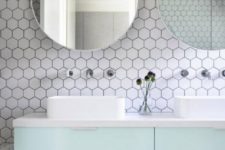 05 white hex tiles with black grout contrast are done fresh and bold with pastel mint cabinets