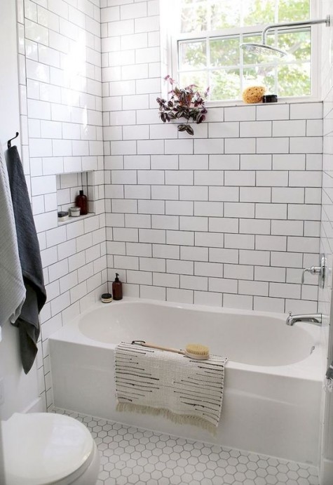 white tiles – subway ones on the walls and hex penny tiles on the floor accented with black grout