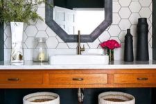 06 white hex tiles with black grout, a geometric mirror in a grey frame, woven baskets for a chic farmhouse look
