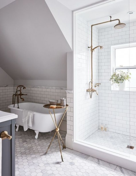 white subway tiles in the shower space and bathtub zone paired with marble hexagon tiles on the floor