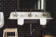 09 black subway tiles with white grout look chic and refined and a black vintage sink match the tiles