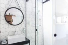 09 white hexagon tiles on the accent wall and grey tiles on the floor create a chic and stylish combo for a bathroom