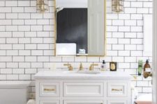11 white subway tiles with black grout look chic and brass details add a refined and chic touch to the space