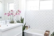 14 black hex penny tiles and white subway tiles create a bold combo for a contempprary bathroom