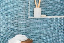 16 blue penny tiles with white grout will make your shower space look very seaside or coastal