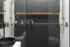 19 black hex tiles with white grout make the shower zone stand out in the neutral bathroom