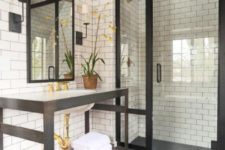 20 a vintage-inspired bathroom with white subway tiles and black grout and black touches here and there for drama