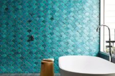 21 a bold turquoise fish scale tile wall is a statement in the bathroom, and neutral grey tiles on the floor