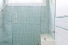 22 turquoise penny tiles with white grout in the shower space make the bathroom look bolder