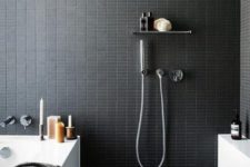23 catchy small black tiles on the walls give your bathroom a sexy feel, and grey tiles on the floor