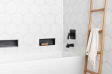 25 a contemporary bathroom with white hex tiles on the walls and grey tiles on the floor