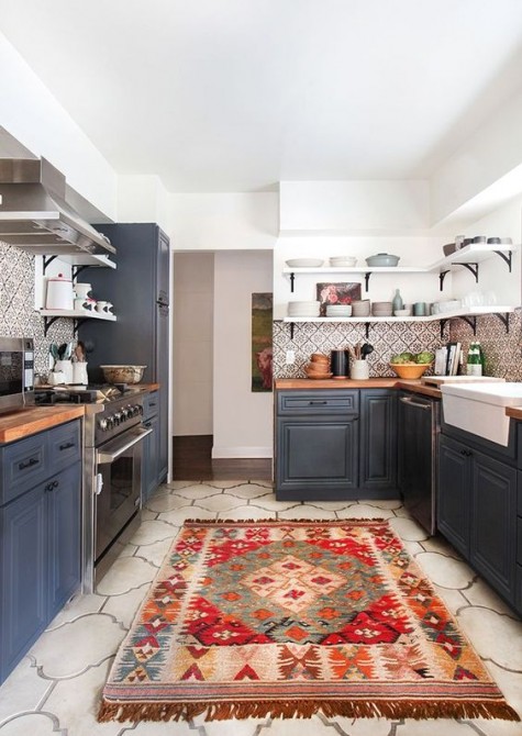 a boho rug and a mosaic tile backsplash make a standard grey kitchen boho and folksy, bold and fun