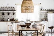 a boho tropical kitchen with a wicker lampshade, a boho rug, rattan chairs, a mosaic tile backsplash