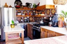 a colorful boho kitchen with a rattan lampshade, a mosaic tile backsplash and wooden furniture