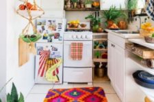 a colorful kitchen with a super bright textiles, a macrame fruit holder and lots of potted greenery