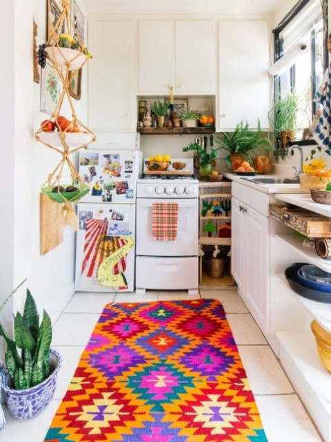 a colorful kitchen with a super bright textiles, a macrame fruit holder and lots of potted greenery