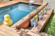 a cozy backyard with a pool and a raised wooden deck, some pillows and fun duck decor is an ultimate space to refresh yourself