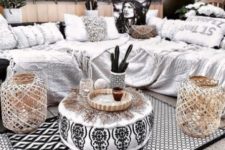 a monochromatic gypsy boho terrace done with woven lanterns, fringe textiles, baskets and potted cacti