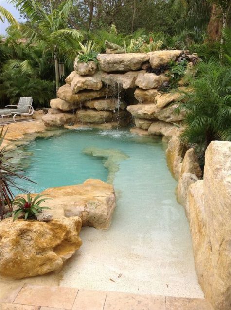 a natural pool surrounded with rocks, with a waterfall, looks like a small lagoon and is a real centerpiece of your outdoor space