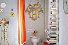 a whimsical bathroom with white subway and penny tiles on the floor, a shower with a gold stand, a gold decoration, a bookshelf and an orange curtain