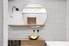a white bathroom fully clad with penny tiles looks absolutely unique, with a stained vanity, shelf and a round mirror