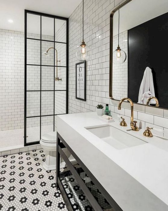 hex penny tiles forming floral patterns on the floor and neutral white subway tiles with black grout on the walls