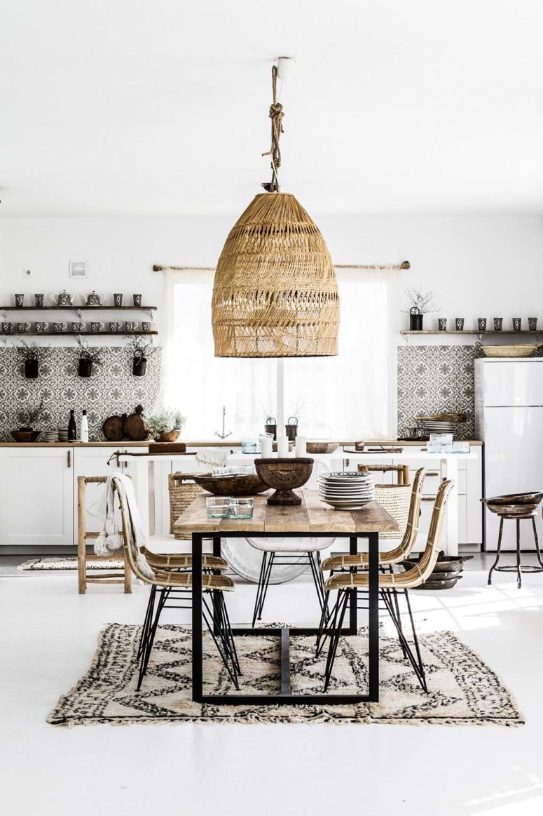 mosaic tiles, a boho rug, a wicker lampshade and chairs make up a nice boho tropical kitchen in neutrals