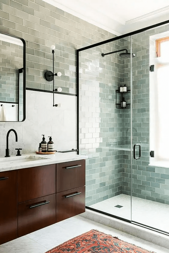 subway tile sin various shades of green create a lovely and calming look in the space and remind of the water surface