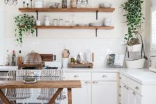 touches of natural wood, potted greenery and a boho rug are all you need for a boho feel in a neutral kitchen