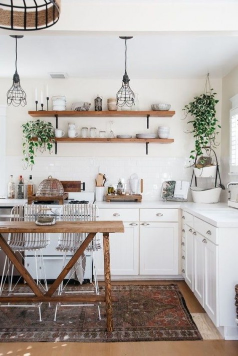 touches of natural wood, potted greenery and a boho rug are all you need for a boho feel in a neutral kitchen