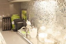 02 an extra shiny kitchen backsplash with small silver tiles and neon green touches for a bold look