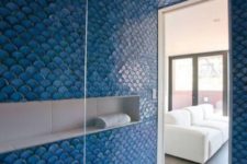 03 a shower space completely covered with blue fishscale tiles looks really mermaid-like and bold, your shower will stand out with such tiles for sure