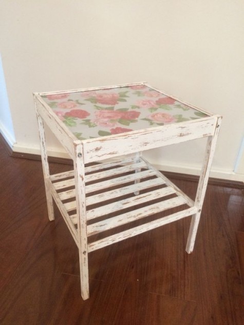 a distressed IKEA Nesna table with vintage floral wallpaper under the glass for a shabby chic or vintage interior