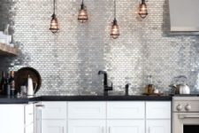04 shiny silver tiles glam up the space and echo with stainless steel appliances
