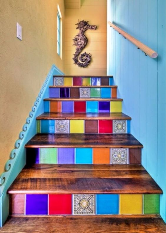 a colorful staircase done with super bright tiles   different for each riser to make the space extra bold