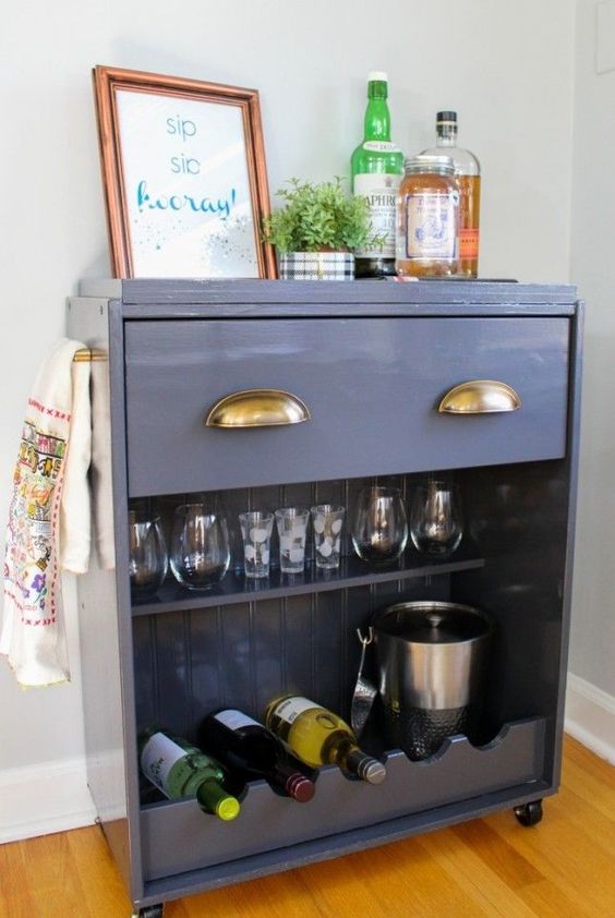 an IKEA Rast dresser turned into a stylish home bar on casters with a drawer and an open storage compartment