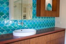 07 bold blue fishscale tiles cover one bathroom wall and make the rich stained furniture stand out a lot
