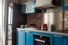 10 a bold blue kitchen with dark touches and a red brick kitchen backsplash plus shiny metal touches