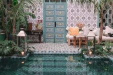 11 a beautiful Moroccan pool space with mosaic tiles, blue inlay doors, potted greenery, lanterns and rattan furniture