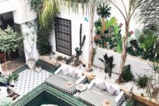 12 a bright Moroccan pool spacefully done with amazing tiles, a pool with steps, potted greenery and a daybed, rugs and an elegant console
